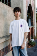 Young man wearing The Different Society Purple Sunflower t-shirt in the colour white